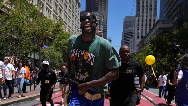 Jun 20, 2022; San Francisco, CA, USA; Golden State Warriors forward Draymond Green runs during the Golden State Warriors championship parade in downtown San Francisco. Mandatory Credit: Darren Yamashita-USA TODAY Sports